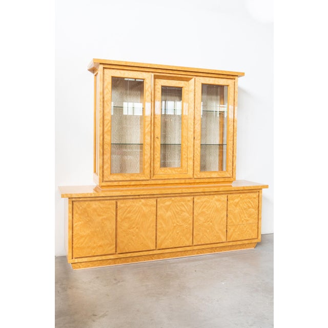 Sideboard cabinet, with glass display case, in birch root, with glass shelves, gold painted iron handles, cut glass. The...
