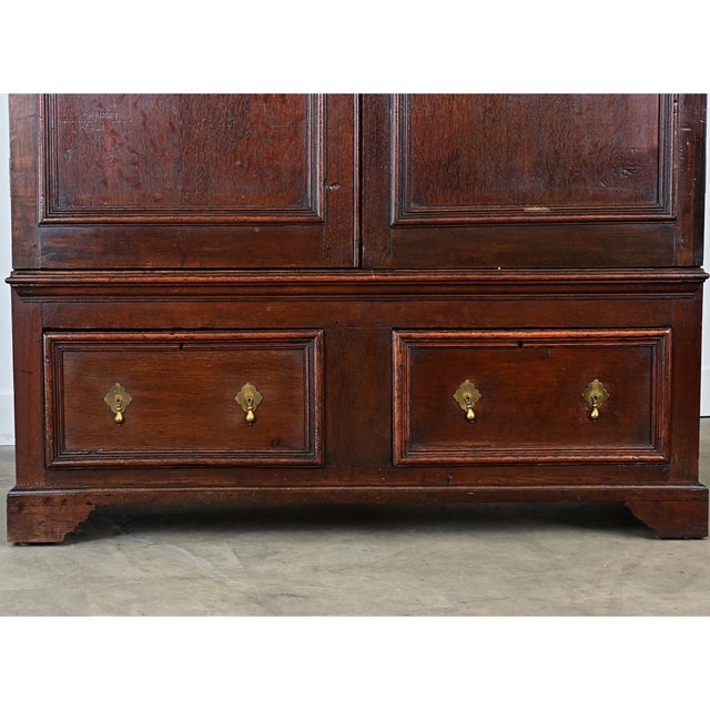 A stunning piece of Dutch craftsmanship dating to the early 19th Century. Made from solid oak, this spacious armoire is...