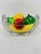 Eight pieces of glass fruit in a metal hammock type bowl. A colorful addition to the kitchen or dining room. This is a...