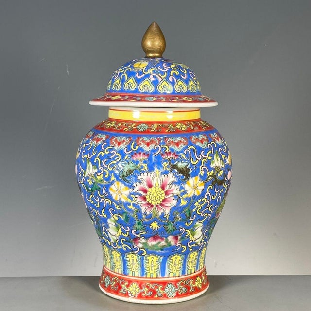 A richly decorated Chinese famille rose porcelain covered jar in the classic "General's jar" form. The royal blue ground...