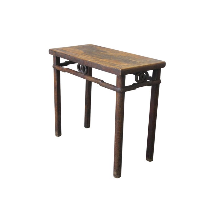 This rectangular side table is made from solid elm with a weathered, natural finish. The design features a recessed apron...