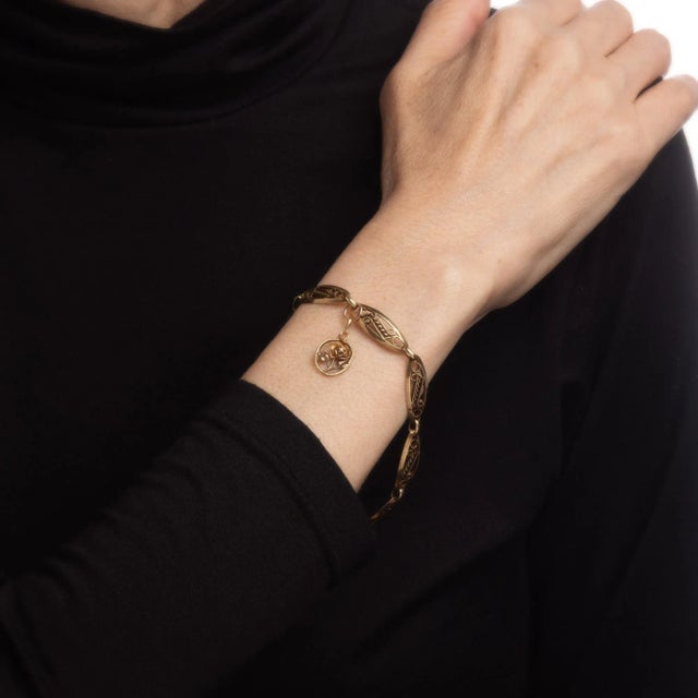 This is part of Chairish’s Fine Jewelry assortment. Finely detailed vintage French charm bracelet crafted in 18k yellow...