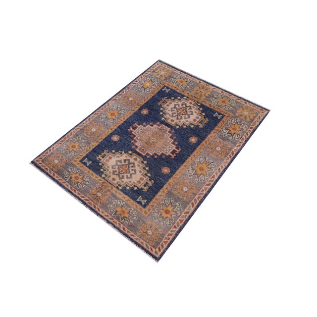 Enhance your home with this exquisite hand-knotted Kazak rug, crafted from fine hand-spun wool and dyed with all-natural...