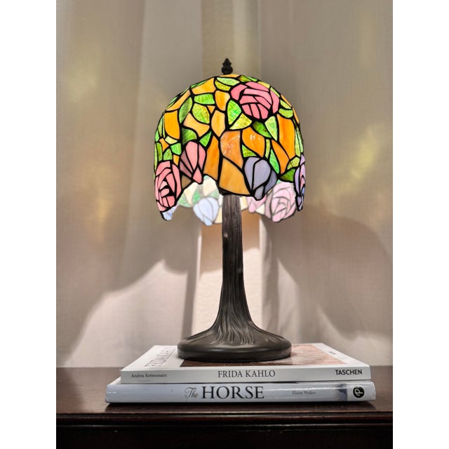Add a touch of timeless Art Nouveau elegance to your space with this beautiful Tiffany-style stained glass accent lamp....