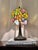 Add a touch of timeless Art Nouveau elegance to your space with this beautiful Tiffany-style stained glass accent lamp....