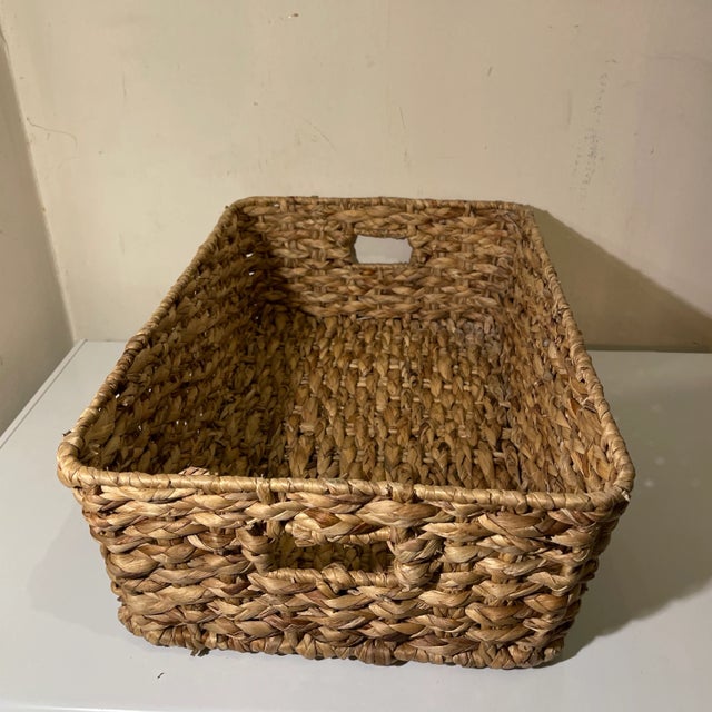 Braided natural woven raffia basket tray with handles. Shallow rectangle with curved corners