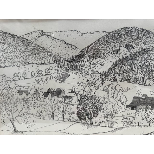 Framed pen and ink landscape drawing by Rosemary and Thomas Naegele, depicting a detailed village and rolling hill scene....