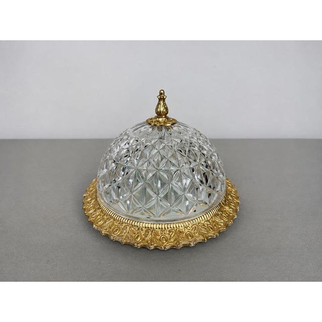 An elegant Vintage French ceiling lamp featuring a domed crystal glass shade with a striking geometric cut pattern,...
