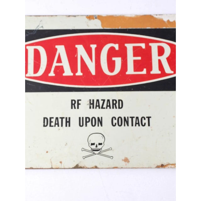 This is a vintage metal "Danger" sign mounted on wood. The early mid 20th century metal radiation warning sign features a...