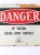 This is a vintage metal "Danger" sign mounted on wood. The early mid 20th century metal radiation warning sign features a...