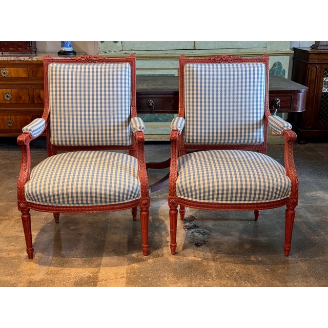 Pair of red painted fauteuils in the Louis XVI taste, the square backs carved with ribbon twist borders and crested with a...