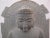 Hand-carved stone sculpture of a seated Buddha performing the Dharmachakra Mudra (the gesture of teaching or turning the...