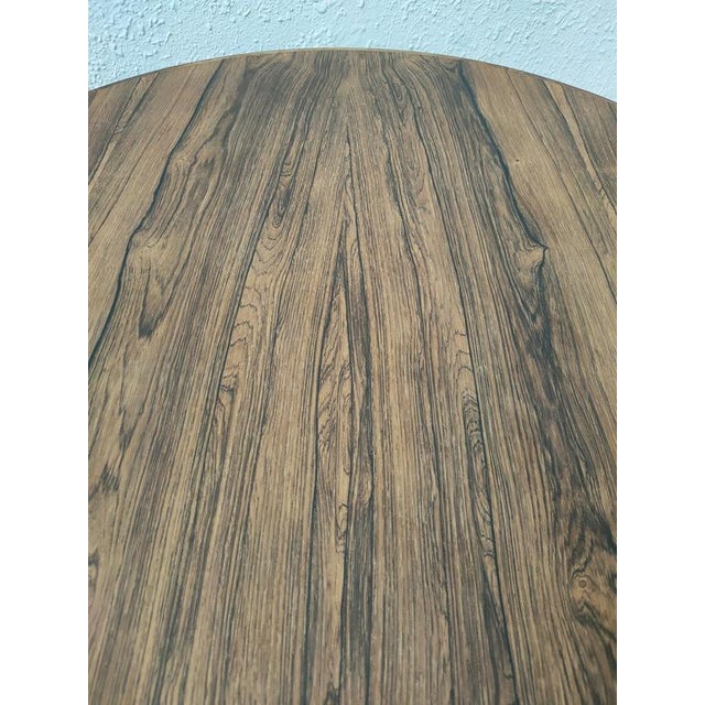 Elegant coffee table with a modern design and quality materials. Made of rosewood in Denmark in the 1970s. Arne Jacobsen...