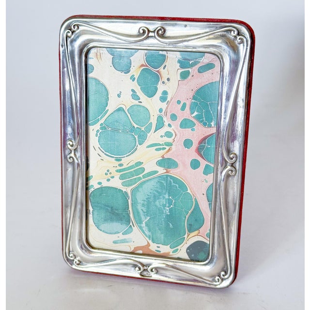 A Beautiful Sterling Silver Repoussé Picture Photo Frame. Featuring lovely scroll work. The easel back is a rich crimson...