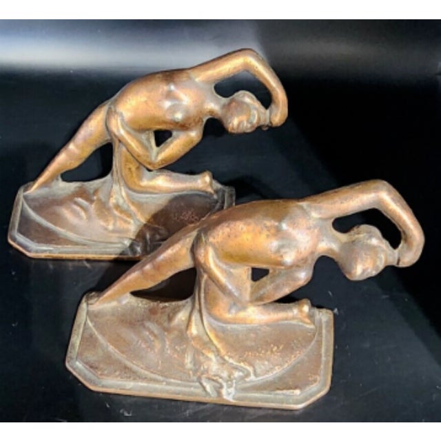 This amazing pair of book ends feature dancing nude women in an art nouveau style in cast iron. Plated in copper, there...