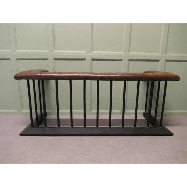 A Wrought Iron and Leather Fire Side Seat, Club Fender This is a grand piece of Country House Furniture with its Buttoned...