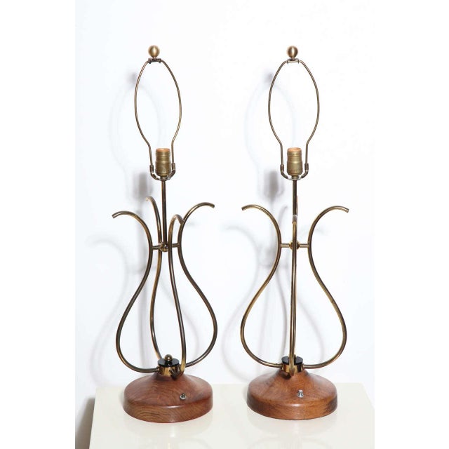 Pair of sculptural french style scrolled Brass Wire and Walnut Table Lamps. Featuring four joined curved S shape patinated...