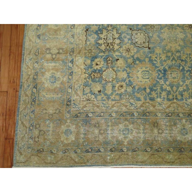 Pale watery blue tightly woven early 20th century Persian Tabriz rug. Measures: 9'5'' x 12'10''.