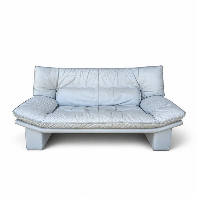 A beautifully sculptural vintage Italian leather loveseat by Nicoletti Salotti, showcasing the relaxed oversized...