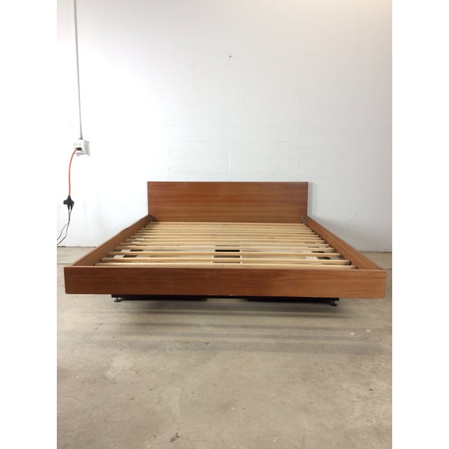 This Danish modern queen sized platform bed features pressed wood construction, teak headboard / rails / and footboard...