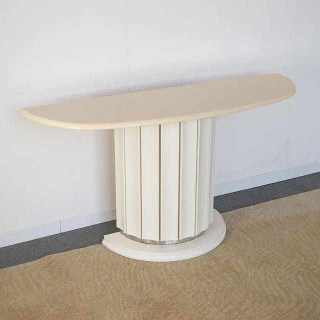 Italian console table from the late 1970s in modern Doric style. White lacquered wood top white lacquered steel base and...