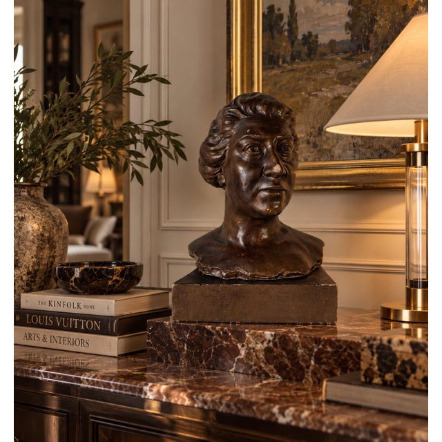 Striking vintage Classical-style portrait bust sculpture signed L. Baldaccini, depicting an elegant woman with finely...