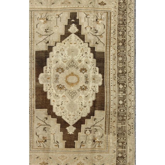 Measures: 6'1 x 9'6. Floral Medallion Turkey Oushak Vintage Rug in Ivory, Taupe, Brown and Olive 6′1″ × 9′6″, Keivan Woven...