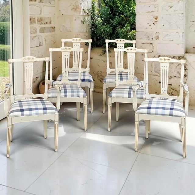 Refined Swedish Gustavian design distinguishes this antique set of six painted dining chairs, including two armchairs and...
