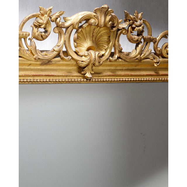 Immerse yourself in the grandeur of this stunning antique French 19th Century Louis Philippe style gold gilt mirror. The...