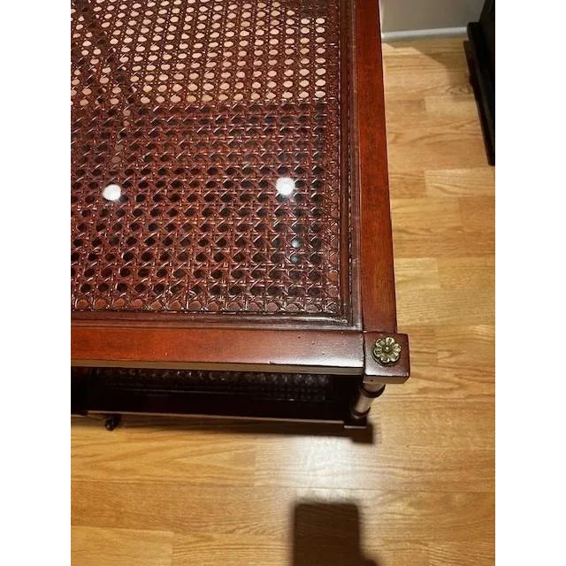 Set of 2 Sherrill Furniture bunching cocktail tables made of cane and glass. Each table sits on brass casters.