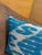 Horizontal white forms ripple across a sky blue silk ground from edge to edge, the resist-dyed threads creating a...