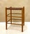 Vintage woven leather stool with a solid oak frame, featuring a handwoven strap seat and clean, architectural lines. The...