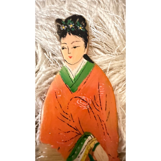 A charming pair of vintage hand-painted figural vanity combs featuring elegant women in traditional Asian-inspired dress....