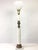 A 1950's Hollywood Regency style ceramic and brass torchiere table lamp by Thomas Industries. A white ceramic column with...