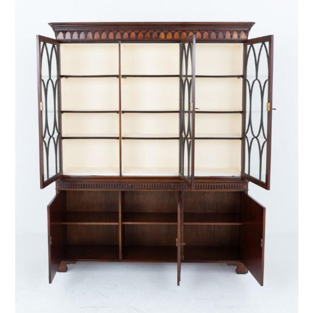 This bookcase stands upon bracket feet Circa 1920 Having 3 lower cupboards which feature wonderful flame mahogany ,...