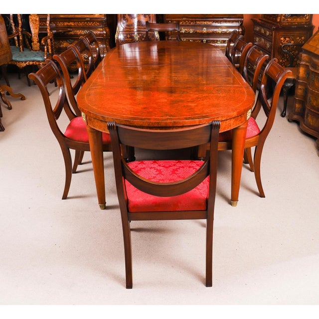 An impressive vintage french empire revival burr walnut dining table and a set of ten swag back dining chairs dating from...