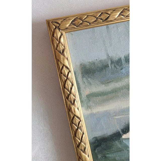 Vintage framed painting on board of a moored sailboat. Newer gold frame finishes this piece perfectly. Signed by the...