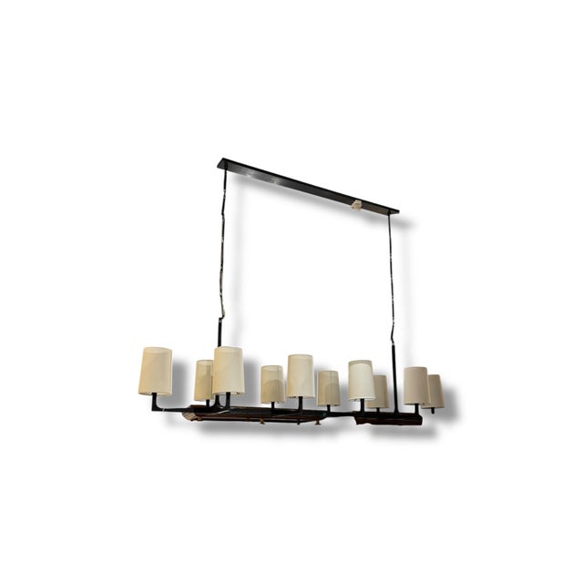 A striking Restoration Hardware chandelier featuring a substantial linear metal frame with a dramatic architectural...