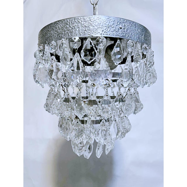 This is an Italian silver rim chandelier dressed with Strass octagon chain and 1.5 inches pendeloque shaped cut crystals....