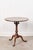 A fine example of Georgian design, this round tilt-top table stands on a turned central column supported by three cabriole...
