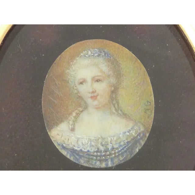 An antique French 19th Century miniature portrait of a lady. The watercolor is hand painted and signed “M.G. Enclosed in a...