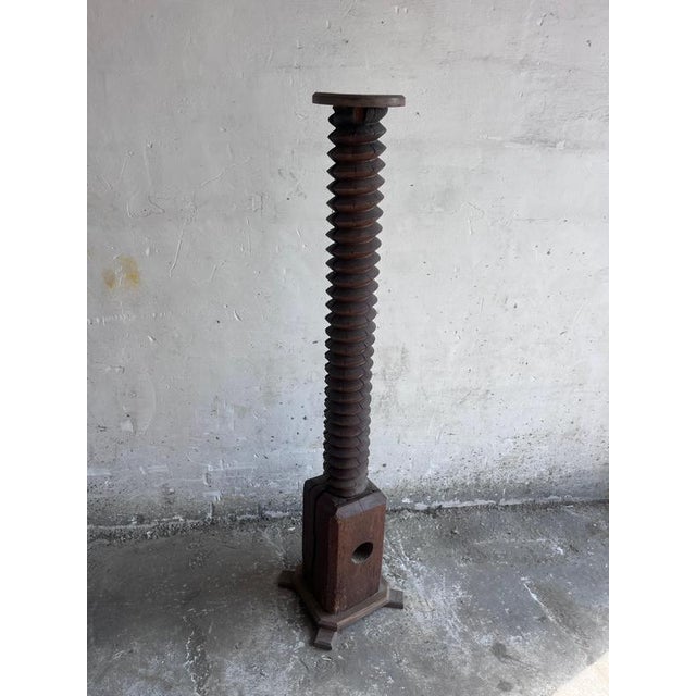 An impressive antique pedestal crafted from the original wooden screw of a traditional wine press. Once used in 19th-...