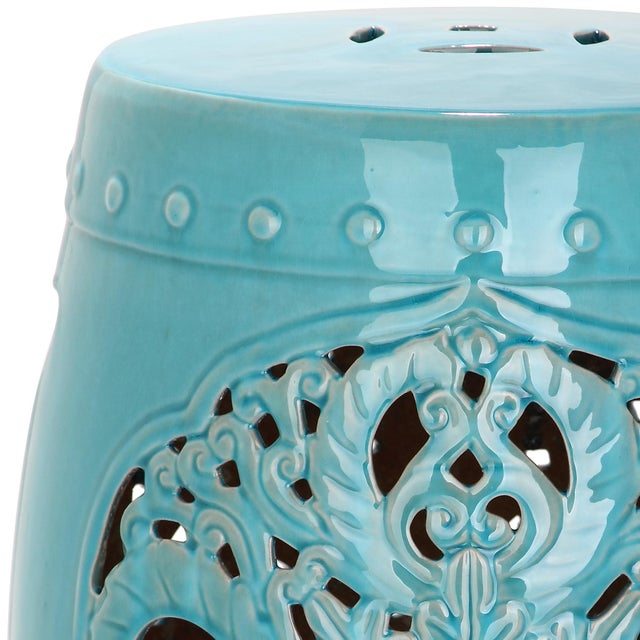 Exquisitely crafted, indoor-outdoor ceramic garden stool in light blue features a pierced leaf medallion motif of Asian...
