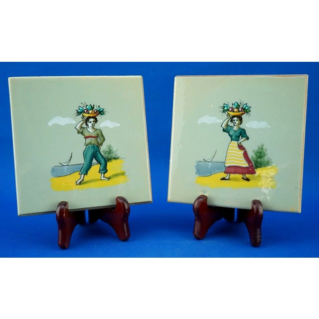 Wonderful pair of majolica tiles, signed on the back by the "AMA Pesaro" factory, depicting two popular subjects, a man...