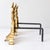 Pair of Italian andirons from the late 19th century, made of gilt bronze and iron and characterized by an elegant...