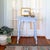 An adorable early 20th-century American farmhouse side table painted in a light matte blue. Details include a scalloped...