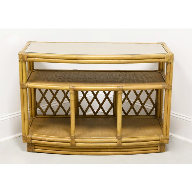 An Asian Inspired bowfront console cabinet, unbranded. Woven cane top & shelves on a wood base with faux bamboo trim,...