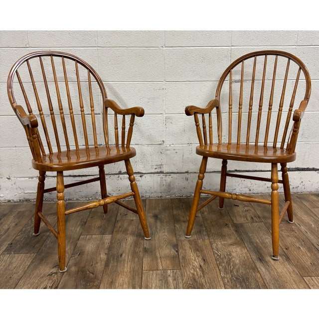 This is a beautiful pair of vintage sack back or hoop back oak Windsor dining arm chairs by S Bent Bros. Beautifully...