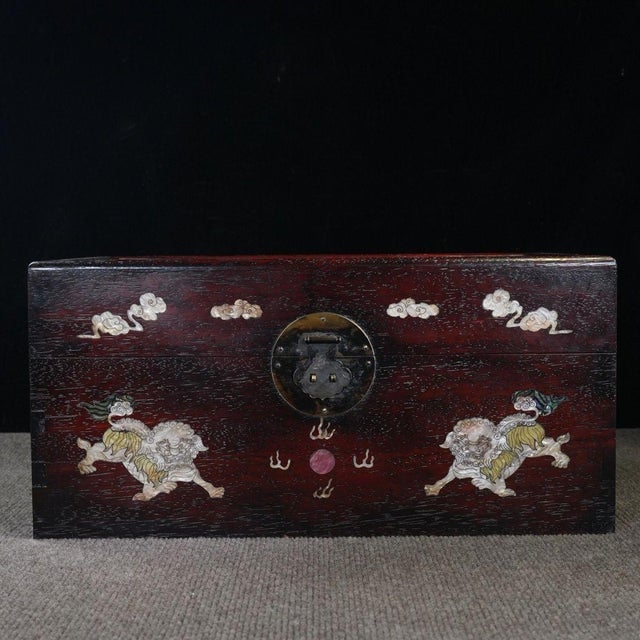 A beautifully crafted Chinese rectangular box, likely made of Zitan wood. The box features a hinged lid with brass...