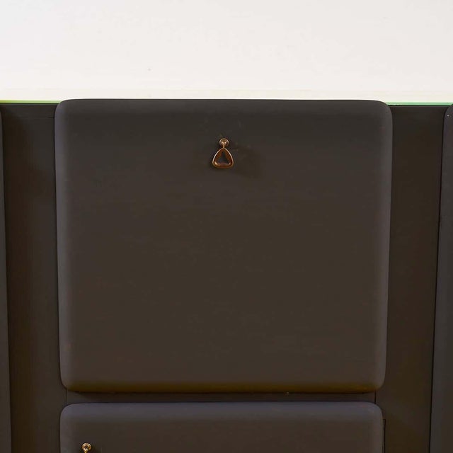 Discover the timeless elegance of this mid-century sideboard. Pairing dark tones with gold details, its unique look is...